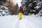 Adventurer, with big backpack, walks in snowshoes