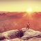 Adventurer on the cliff and looks into amazing sunny day awaiking