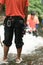 Adventurer climbing in waterfall in rainforest