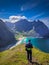 Adventurer hiking on mount  Ryten with view over the Kvalvika Beach