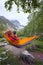 Adventurer relaxing in hammock in the mountains, takes a photo u