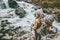 Adventurer travel woman hiking with backpack at river in mountains
