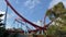 adventures on big roller attraction Dragon Khan in the amusement park PortAventura World - group of happy people go down