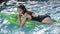 Adventures of girl on crocodile. Relax in luxury swimming pool. woman on sea with inflatable mattress. Summer vacation