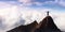 Adventurous Adult Man Hiker on top of Rocky Mountain with hands open.