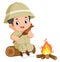 an adventurous boy sits on a fallen tree and is eating grilled fish in front of a bonfire