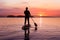 Adventurous Caucasian Adult Woman on a Stand Up Paddle Board