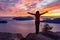 Adventurous Caucasian Girl standing on top of a mountain