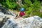 Adventurous, courageous woman climber on a via ferrata route called Casa Zmeului, a popular tourist attraction near Vadu Crisului