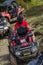 Adventurous driving of ATV motorbikes. A man drives a quad bike on dangerous roads