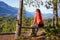 Adventurous Female Hiker is sitting on a bench and enjoying the beautiful Canadian Mountain Landscape