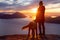 Adventurous Girl Hiking on top of a Mountain with a dog