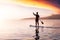 Adventurous girl on a paddle board is paddeling in the Pacific West Coast Ocean