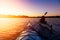 Adventurous Girl Sea Kayaking during a vibrant winter sunrise