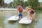 Adventurous girl taking stand up paddle class