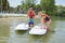 Adventurous girl taking stand up paddle class