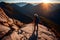 Adventurous lone hiker on mountain peak at golden hour