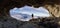 Adventurous Man Hiker standing in an Ice Cave with rocky mountains in background. Adventure Composite