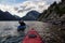 Adventurous Man Kayaking in Glacier Lake surrounded by the beautiful Canadian Rocky Mountains