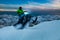 Adventurous Man Riding a Snowmobile in white snow