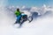 Adventurous Man Riding a Snowmobile in white snow