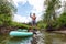 Adventurous people paddle boarding in a river