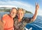 Adventurous senior couple taking selfie at Giglio Island