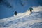 Adventurous skiers carving through the breathtaking snowscape of the Alps