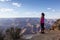 Adventurous Traveler standing on Desert Rocky Mountain American Landscape