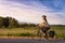 Adventurous White Cacasusian Woman riding a bicycle on a road.