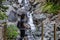 Adventurous White Caucasin Adult Woman Hiking on a trail in Canadian Nature