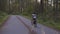 Adventurous Woman Bike Riding on a Trail in Forest