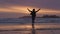 Adventurous woman standing on the sandy beach on the west coast of Pacific Ocean