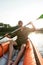 Adventurous young man looking away while kayaking in a lake on a summer day