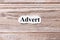 Advert of the word on paper. concept. Words of Advert on a wooden background