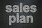 Advertising concept: Sales Plan on chalkboard background
