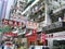 Advertising signs in Chinese language hanging over a street in the Mongkok district