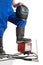 The advertizing image of a lower body of the worker with the welding tool.