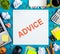 Advice motivation. Office table desk with supplies, white blank note pad, cup, pen, pc, crumpled paper, flower on wooden