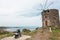 Aegean sea and landscape with old mill and local person bike. Natural scene on green country hill