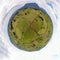 Aerial 360-degree shot of green rural fields and white clouds in the sky