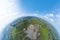 Aerial 360 panoramic of opencast mining quarry minerals with many machinery tractors and trucks surrounded by green fields