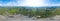 Aerial 360 panoramic of opencast mining quarry minerals with many machinery tractors and trucks surrounded by green fields