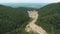 Aerial 4k drone video of top vew of winding road in the mountains