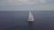 Aerial 4K footage of luxury catamaran yacht with white and red sail in blue seas