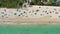 Aerial 4k footage of people  a good time on the beach in Miami beach