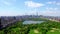 Aerial 4k video above green Central park in the middle of Manhattan, New York
