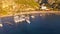 Aerial 4K video fly around of sailboats anchoring at sea berth