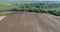 Aerial 4K video of flying drone over the Desna river, Studentsy village and ploughed land from the birds sight