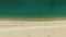 Aerial above shot of empty sandy beach and ocean with waves